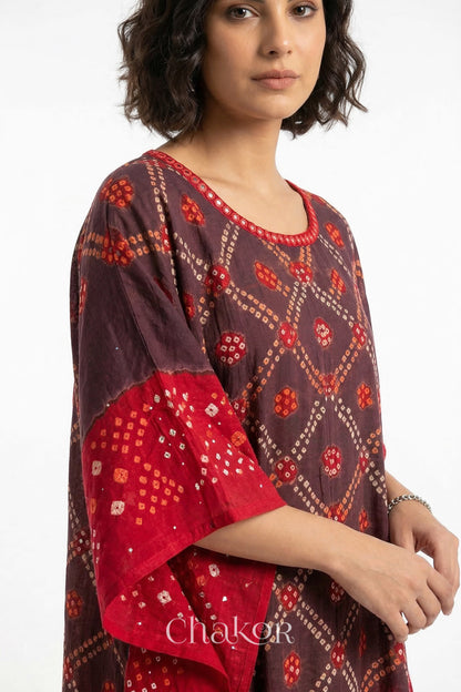 Mirror work neckline detail on mulmul cotton bandhani kaftan in brown and red, handcrafted in Kutch.
