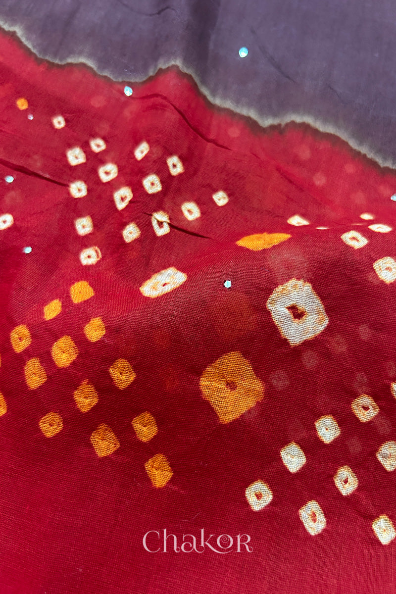 Mulmul cotton bandhani fabric with mukaish embroidery detail in brown and red.
