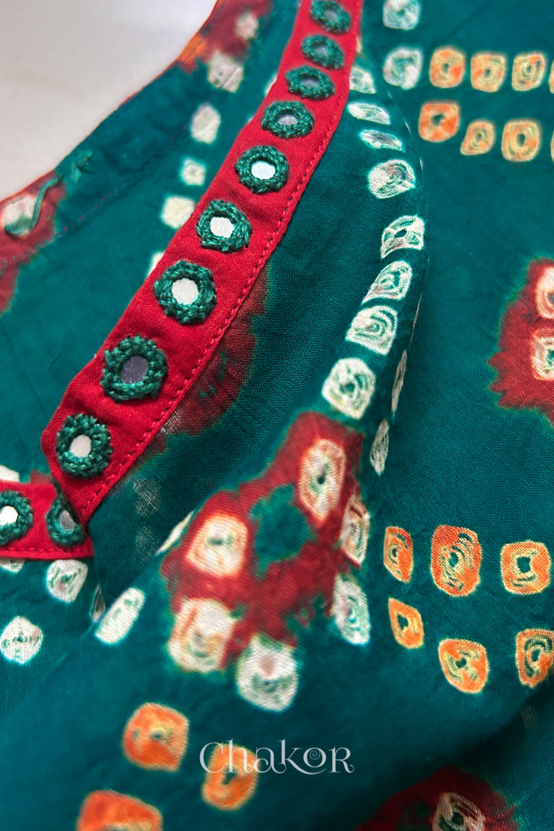 Mirror work neckline detail on mulmul cotton bandhani kaftan in green and red, handcrafted in Kutch.
