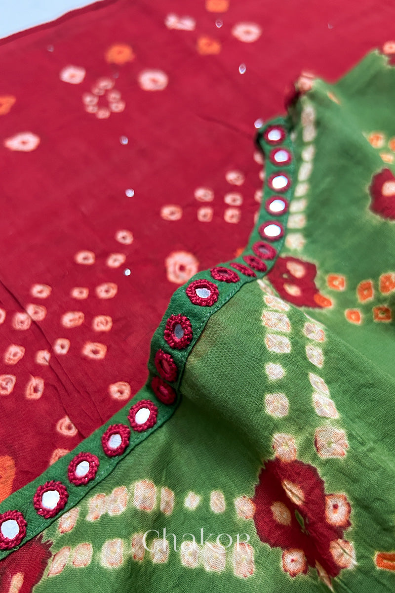 Mirror work neckline detail on mulmul cotton bandhani kaftan in green and red, handcrafted in Kutch.