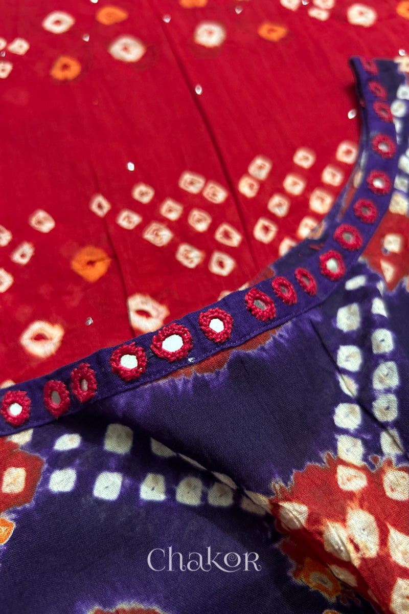 Mirror work neckline detail on mulmul cotton bandhani kaftan in purple and red, handcrafted in Kutch.
