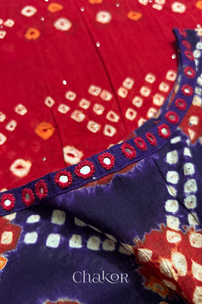 Mirror work neckline detail on mulmul cotton bandhani kaftan in purple and red, handcrafted in Kutch.
