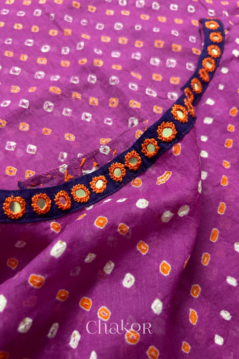 Mirror work neckline detail on mulmul cotton bandhani kaftan in magenta, handcrafted in Kutch.
