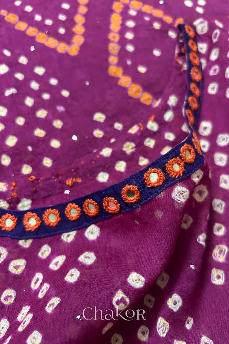 Mirror work neckline detail on mulmul cotton bandhani kaftan in magenta, handcrafted in Kutch.
