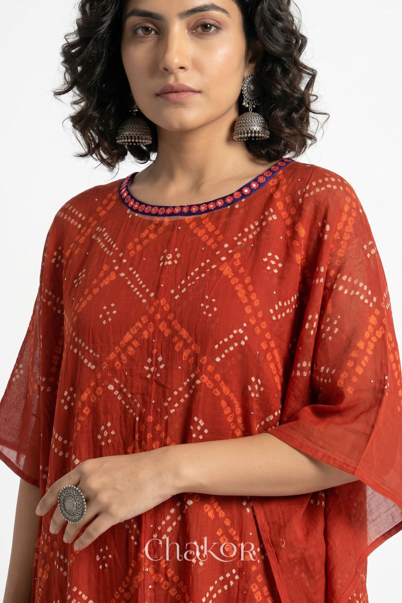 Bandhani kaftan neckline with mirror work detail in rusty orange mulmul cotton for summer.
