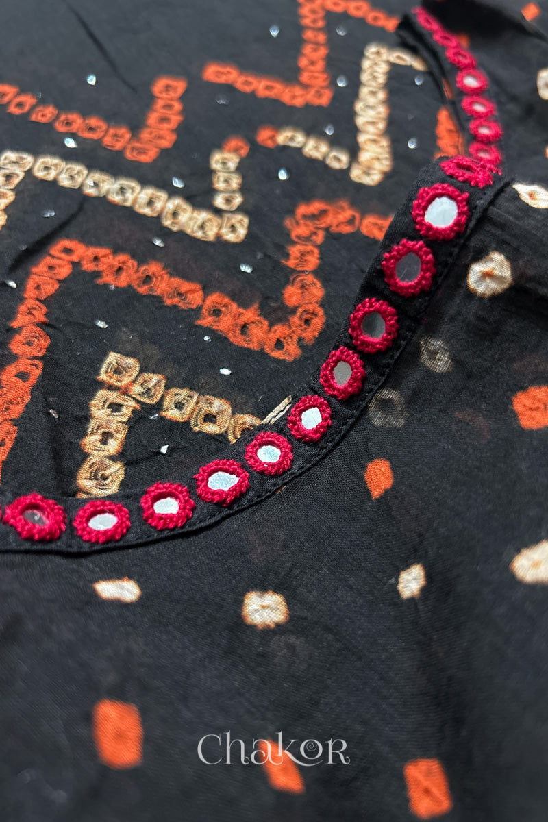 Mirror work neckline detail on mulmul cotton bandhani kaftan in black, handcrafted in Kutch.
