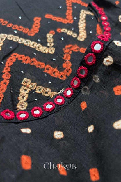 Mirror work neckline detail on mulmul cotton bandhani kaftan in black, handcrafted in Kutch.
