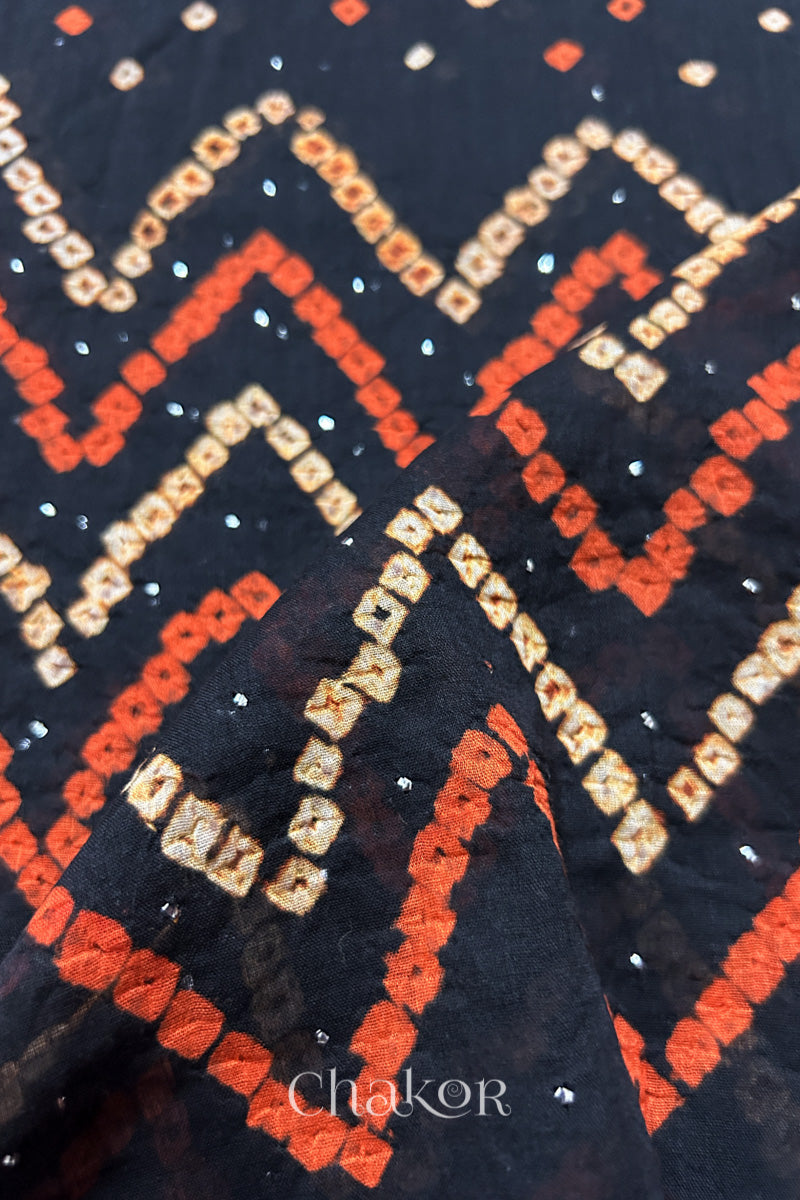 Mulmul cotton bandhani fabric with mukaish embroidery detail in black.
