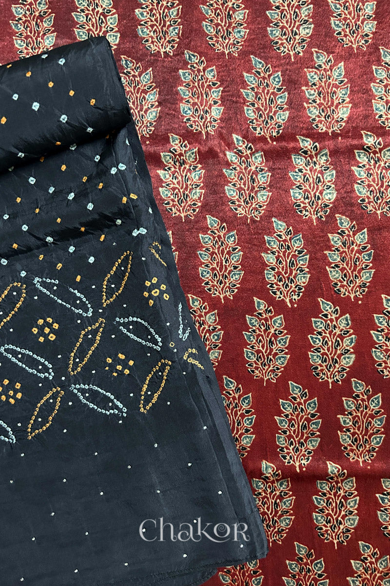 Madder red ajrakh block printed mashru silk kurta fabric paired with black bandhani mulberry silk dupatta featuring mukaish work on pallu.