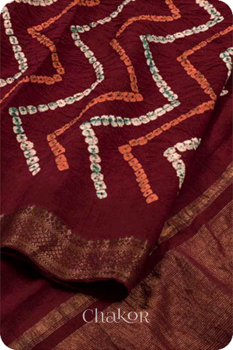 Maroon Traditional Bandhani Mangalgiri Cotton Saree with zari border and pallu by Chakor.