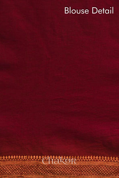 Blouse detail of red bandhani saree with woven golden zari border.
