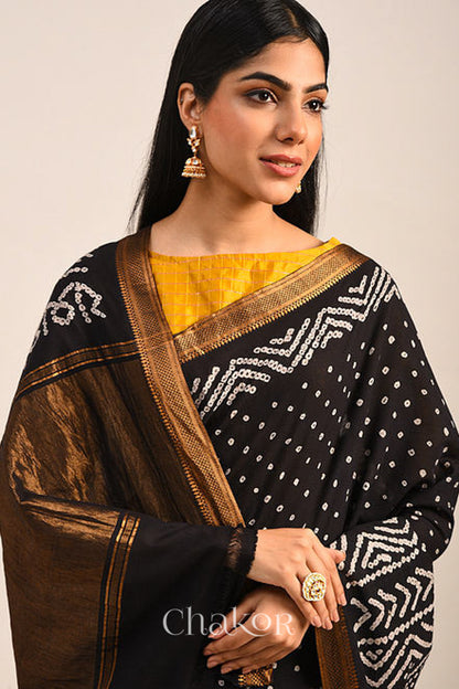 Black Bandhani Mangalgiri Cotton Saree with zari border and pallu by Chakor.Black Bandhani Mangalgiri Cotton Saree with zari border and pallu by Chakor.