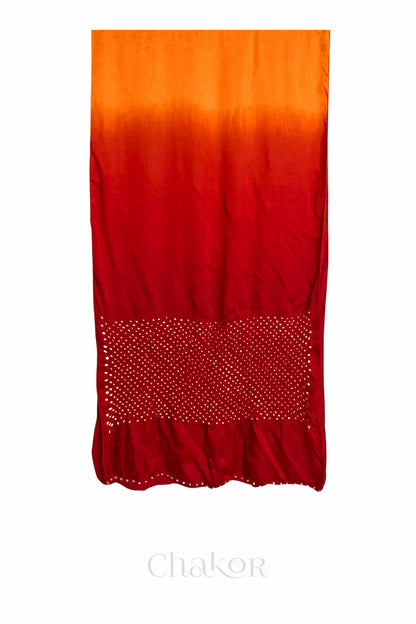 Full view of bandhani stole featuring ombre dyeing in orange & red and lustrous texture of modal fabric with 'Chakor' branding.
