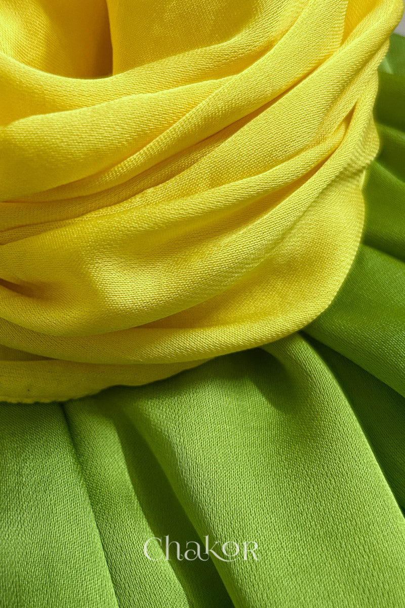 Close-up of bandhani stole featuring ombre dyeing in Yellow & green on lustrous modal fabric with 'Chakor' branding.
