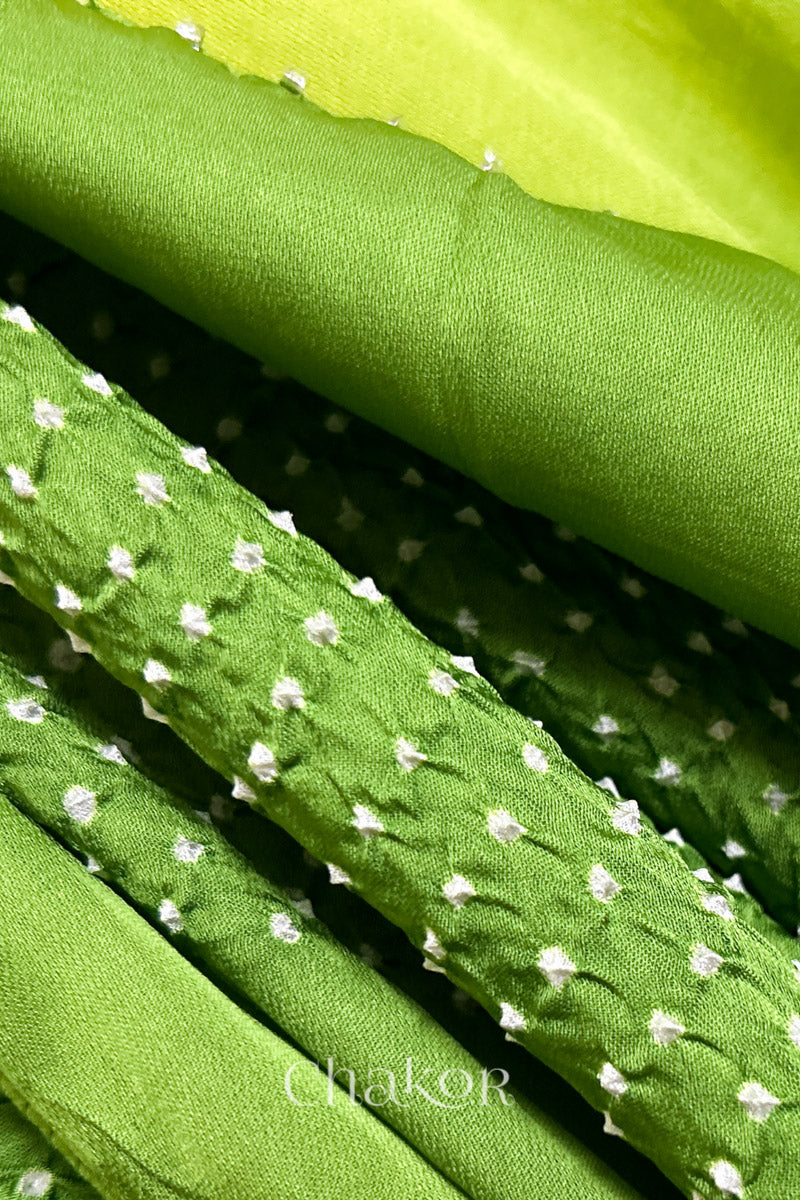 Close-up of bandhani stole featuring ombre dyeing in Yellow & green on lustrous modal fabric with 'Chakor' branding.
