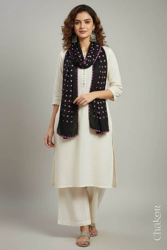 Model wearing a black Bandhani modal stole styled over a kurta, showing hand tie-dye patterns.
