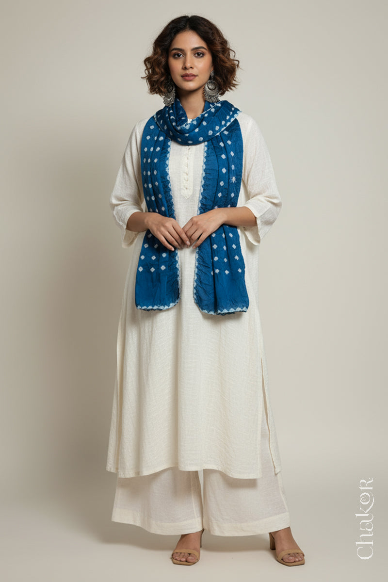 Model wearing a indigo Bandhani modal stole styled over a kurta, showing hand tie-dye patterns.
