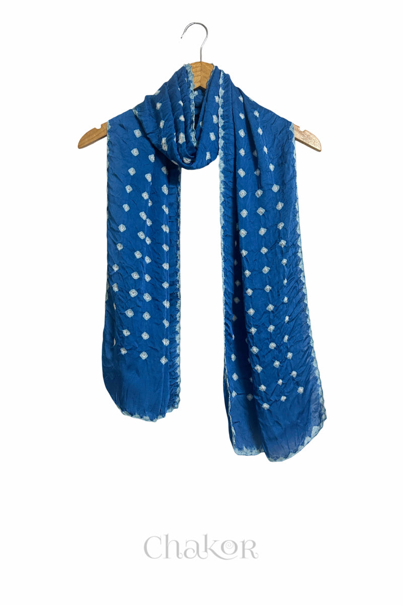 indigo Bandhani modal stole displayed on wooden hanger showing full length, drape and tie-dye layout.
