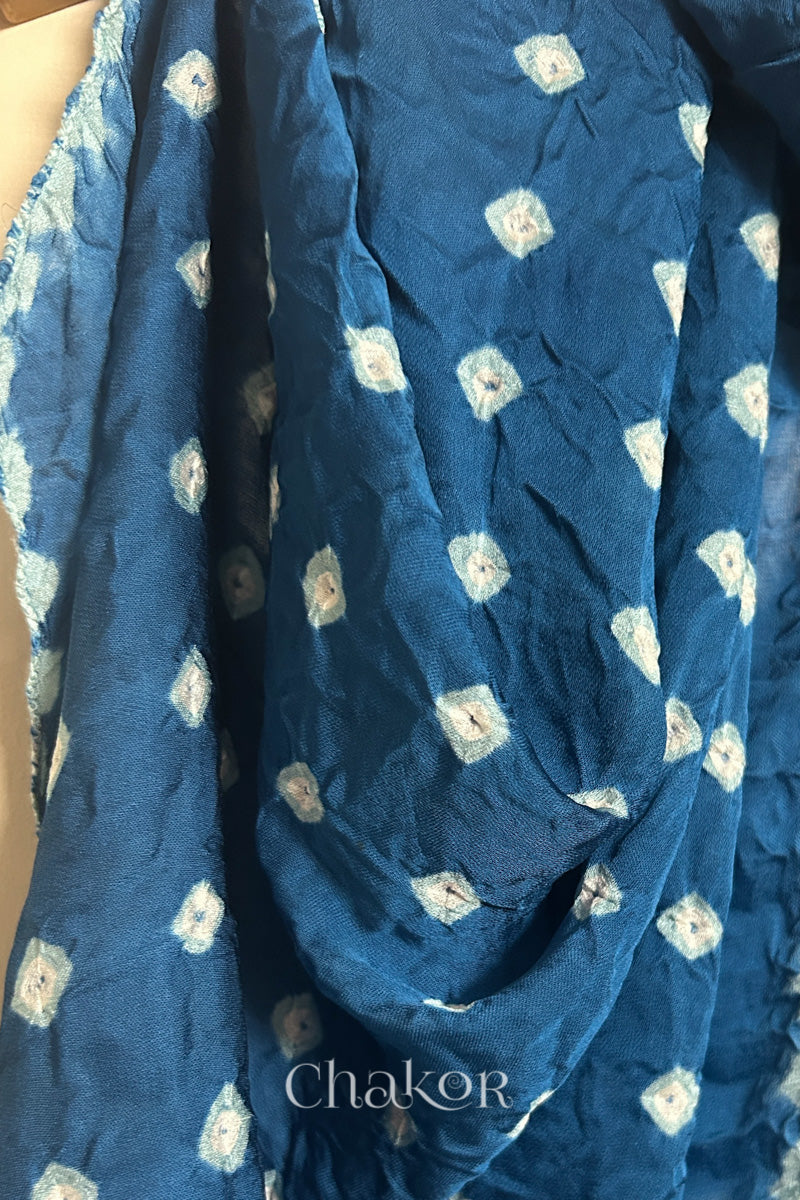 Close-up of hand tie-dye texture on indigo Bandhani stole in modal fabric.
