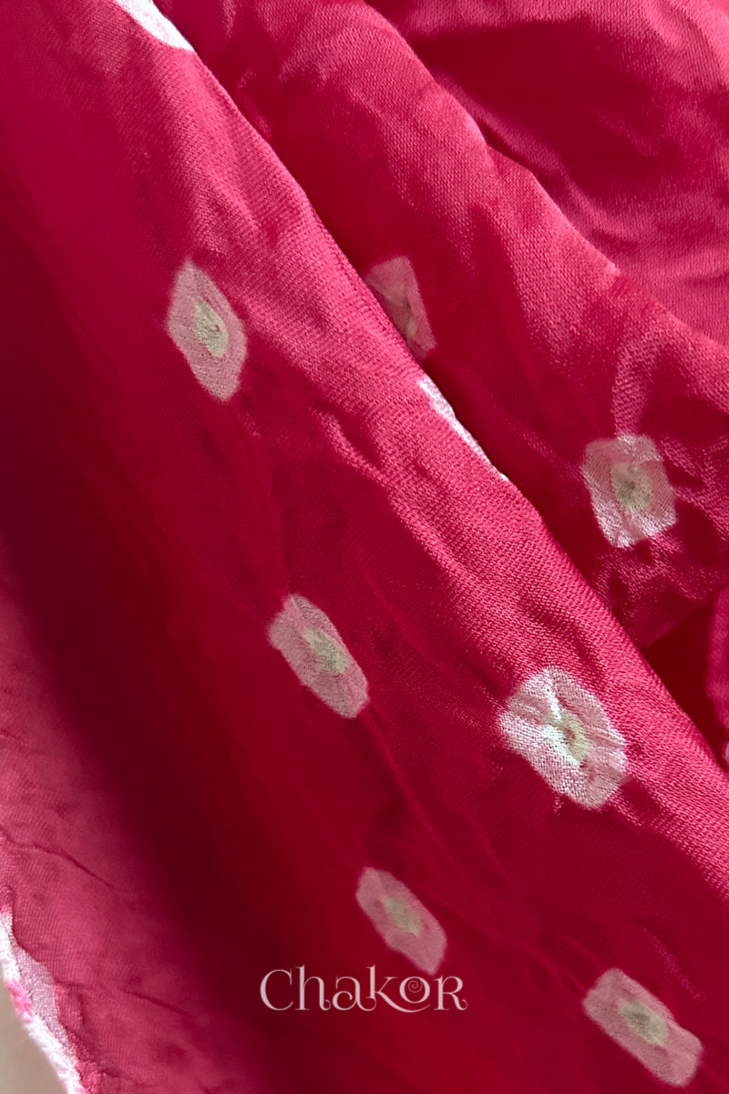 Close-up of hand tie-dye texture on pink Bandhani stole in modal fabric.
