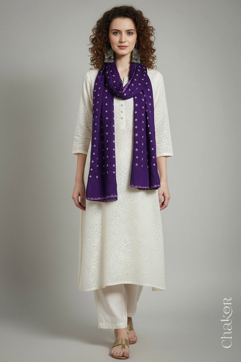 Model wearing a purple Bandhani modal stole styled over a kurta, showing hand tie-dye patterns.
