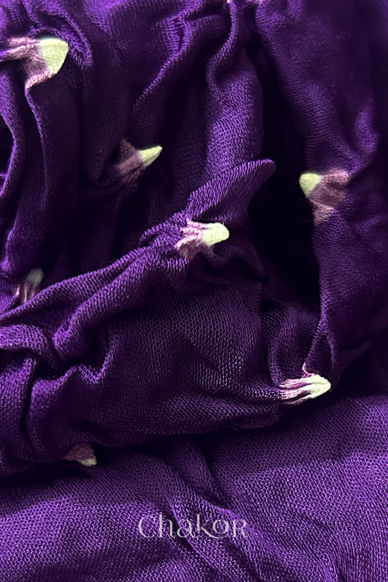 Close-up of purple Bandhani modal fabric showing hand tie-dye Chakri motifs.
