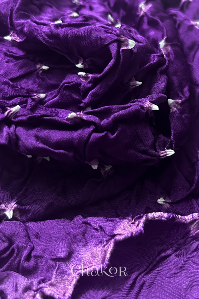 Close-up of purple Bandhani modal fabric showing hand tie-dye Chakri motifs.
