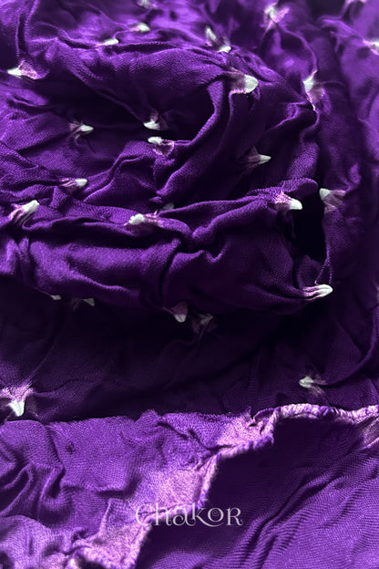 Close-up of purple Bandhani modal fabric showing hand tie-dye Chakri motifs.
