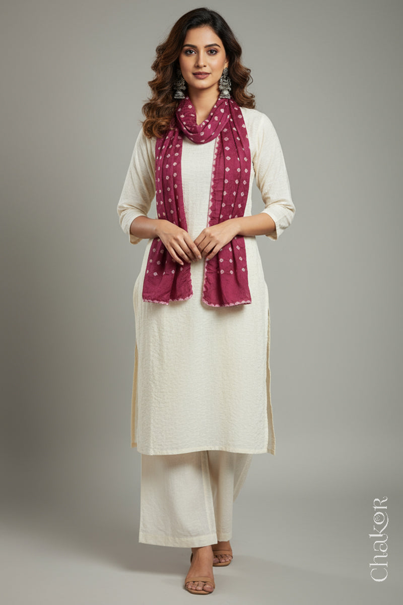 Model wearing a raspberry pink Bandhani modal stole styled over a kurta, showing hand tie-dye patterns.
