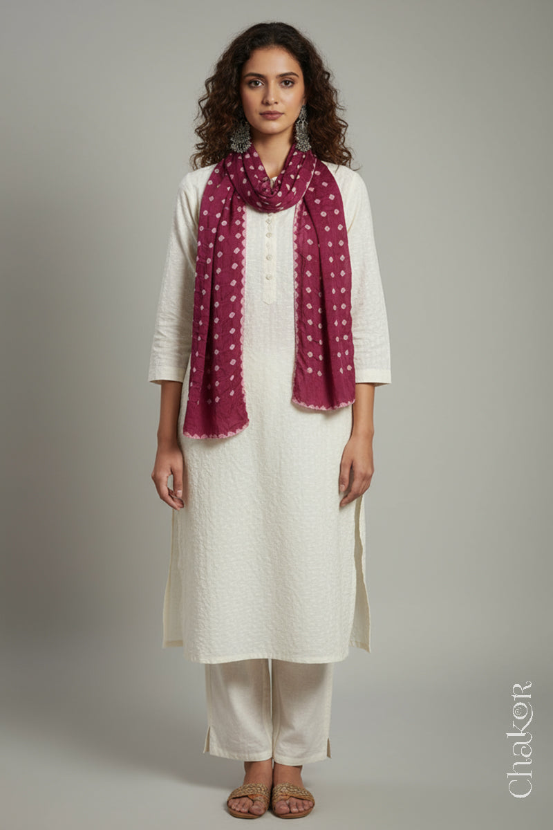 Model wearing a raspberry pink Bandhani modal stole styled over a kurta, showing hand tie-dye patterns.
