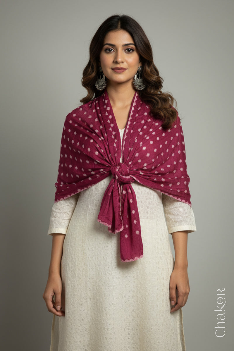 Model wearing a raspberry pink Bandhani modal stole styled with a front knot over a kurta, showing hand tie-dye patterns.
