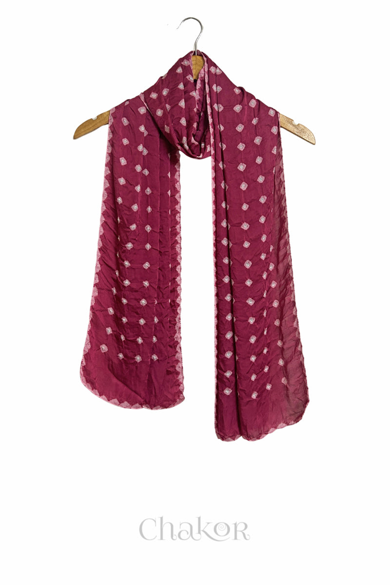 raspberry pink Bandhani modal stole displayed on wooden hanger showing full length, drape and tie-dye layout.
