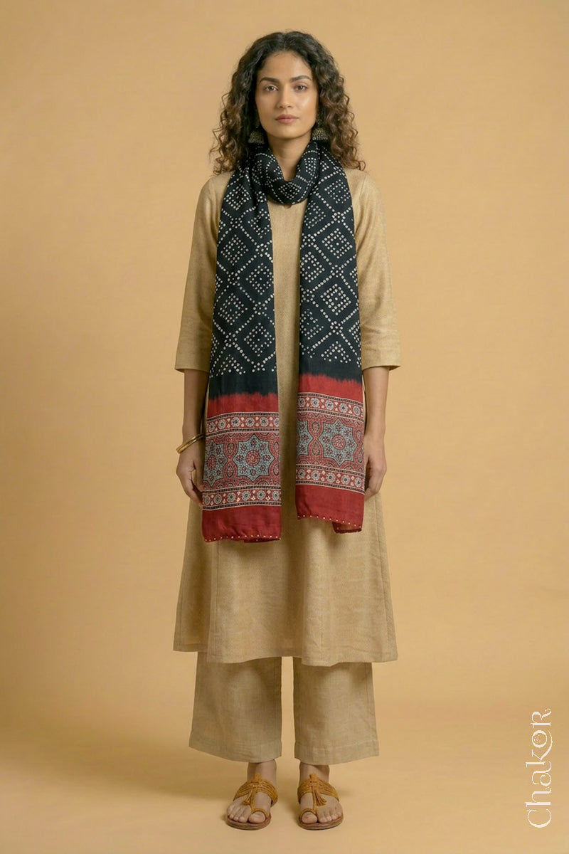 Full length view of handcrafted Black Bandhani stole with iron  Madder Red Ajrakh pallu worn as dupatta wrapped around the neck.
