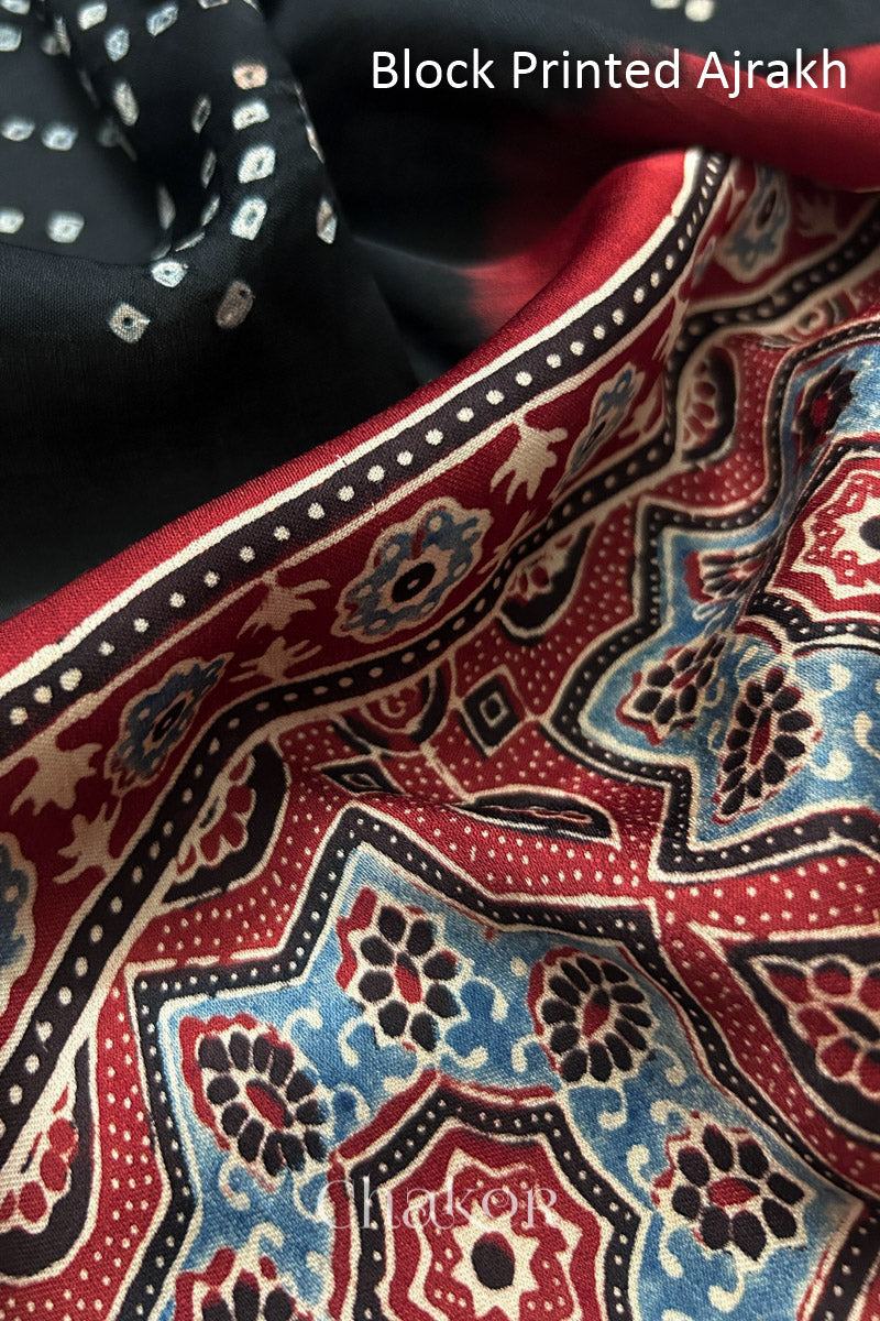 Detailed Ajrakh pattern on modal stole showing traditional hand block printing and intricate bandhani motifs.
