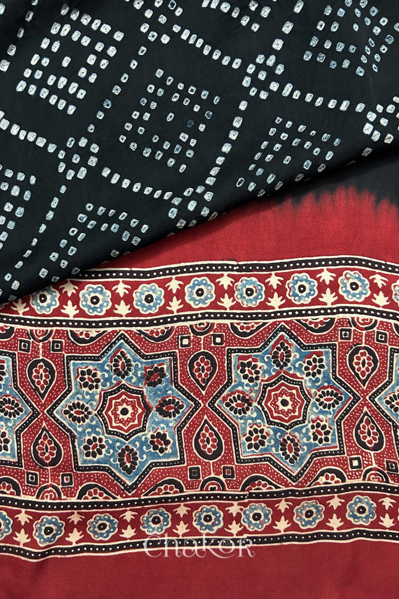 Hand tied Black Bandhani patterns on modal stole with contrast Manjistha Red Ajrakh pallu detail.
