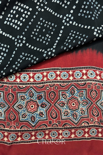 Hand tied Black Bandhani patterns on modal stole with contrast Manjistha Red Ajrakh pallu detail.
