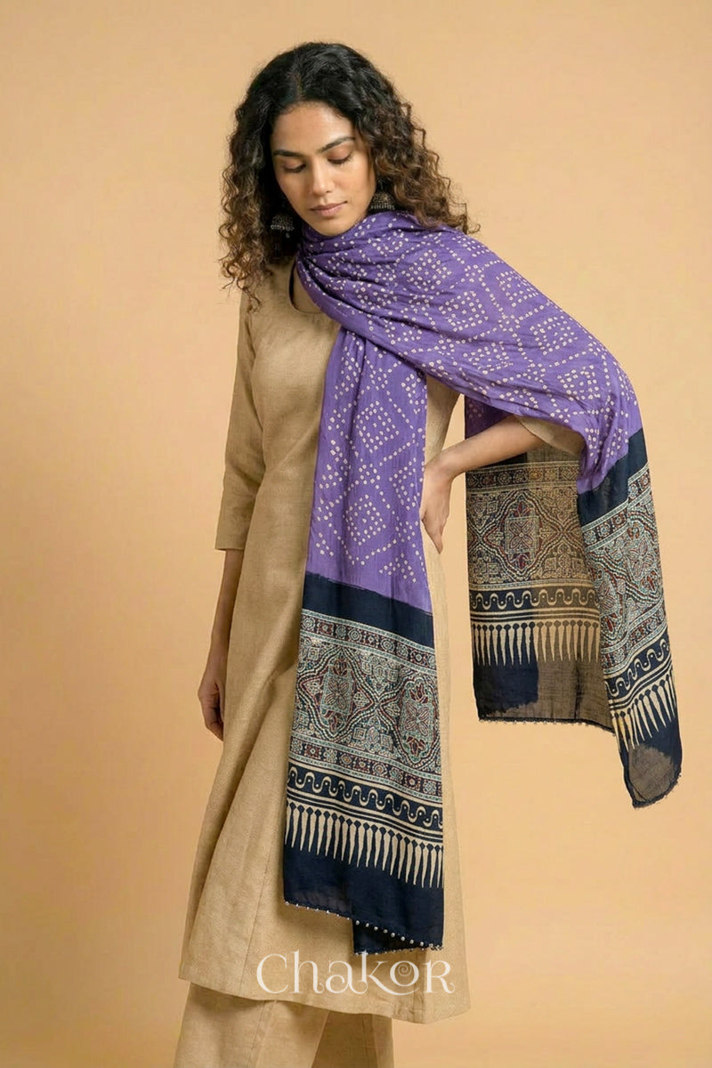 Mauve bandhani modal stole styled across shoulders with detailed black Ajrakh pallu and traditional hand tied pattern.

