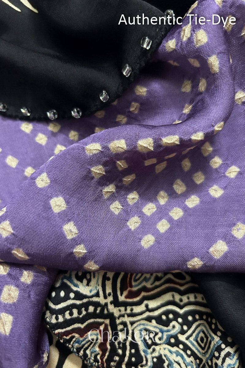 Mauve Hand tied Bandhani dots on modal stole with contrast ajrakh pallu detail.
