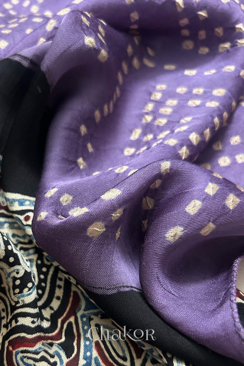 Mauve Hand tied Bandhani dots on modal stole with contrast ajrakh pallu detail showcasing fabric texture and softness.
