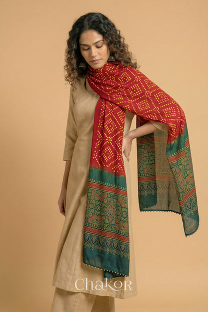  Red Bandhani modal stole styled across shoulders with detailed Green Ajrakh pallu and traditional hand tied pattern.
