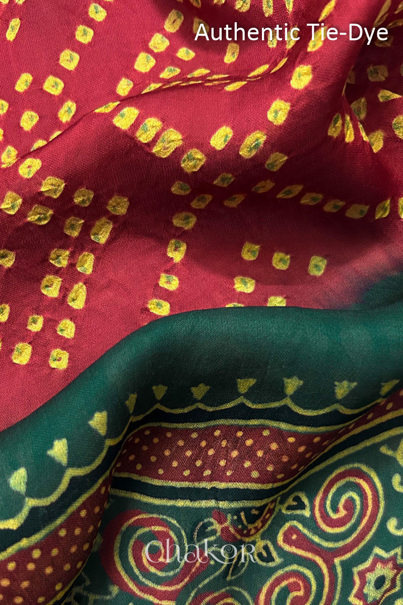 Red Hand tied Bandhani dots on modal stole with contrast ajrakh pallu detail showcasing fabric texture and softness.
