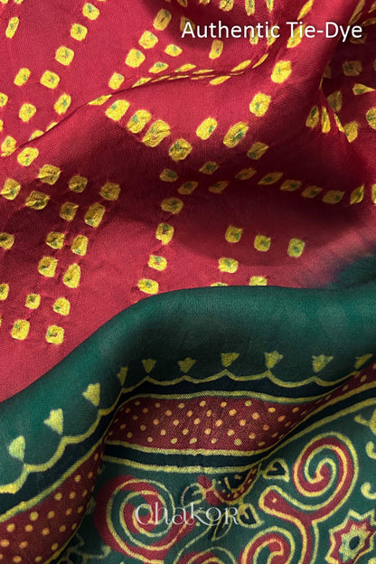 Red Hand tied Bandhani dots on modal stole with contrast ajrakh pallu detail showcasing fabric texture and softness.
