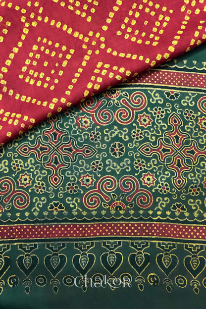 Hand tied  Red Bandhani patterns on modal stole with contrast   Red Ajrakh pallu detail.
