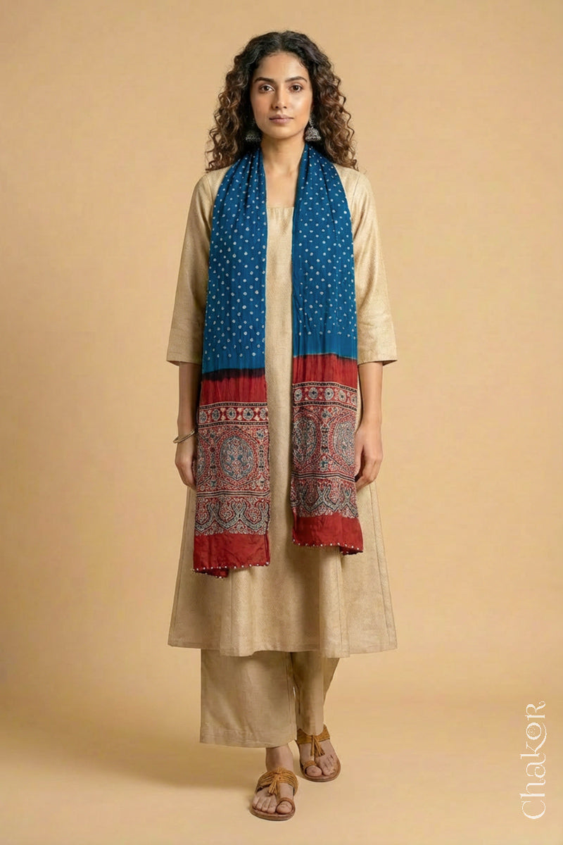 Handcrafted Bandhani Ajrakh modal stole draped on model with blue Bandhani body and red Ajrakh pallu.
