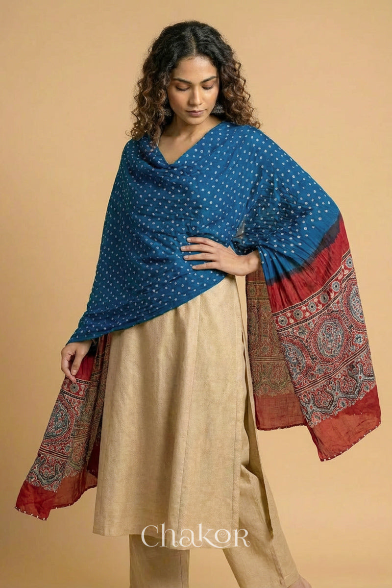 Blue Bandhani modal stole styled across shoulders with detailed Manjistha Red Ajrakh pallu and traditional hand tied pattern.
