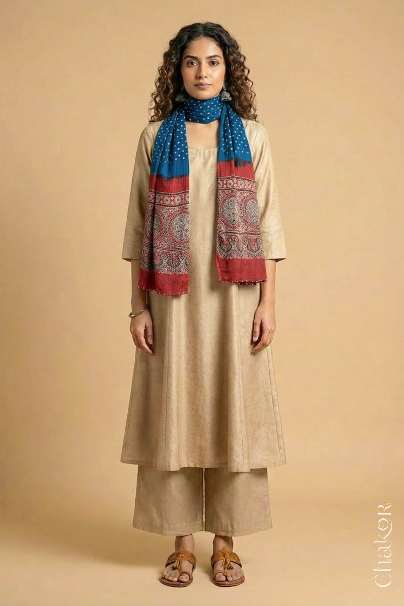 Full length view of handcrafted blue Bandhani stole with madder red ajrakh pallu worn as dupatta wrapped around the neck.
