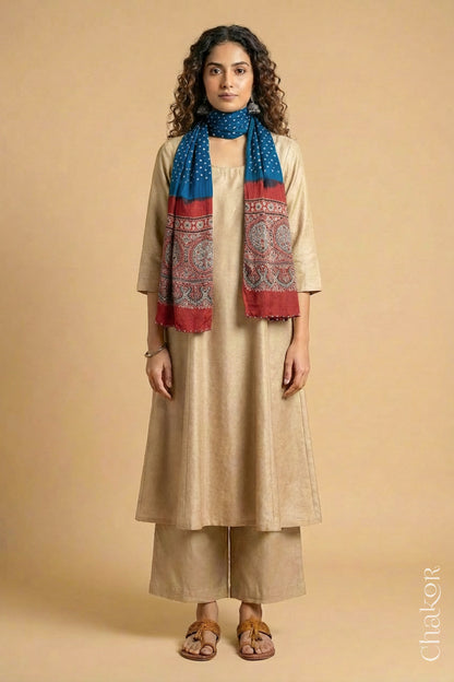 Full length view of handcrafted blue Bandhani stole with madder red ajrakh pallu worn as dupatta wrapped around the neck.
