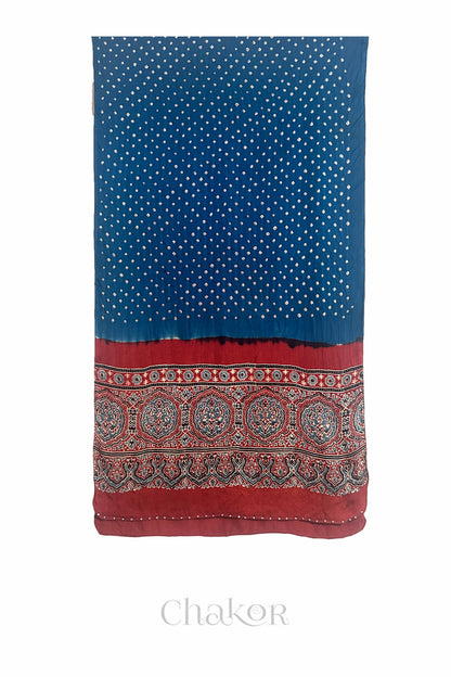 Blue Bandhani modal stole with red Ajrakh pallu and traditional block print layout and glass bead edging.
