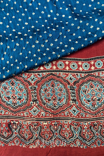 Blue Hand tied Bandhani patterns on modal stole with contrast red ajrakh pallu detail.

