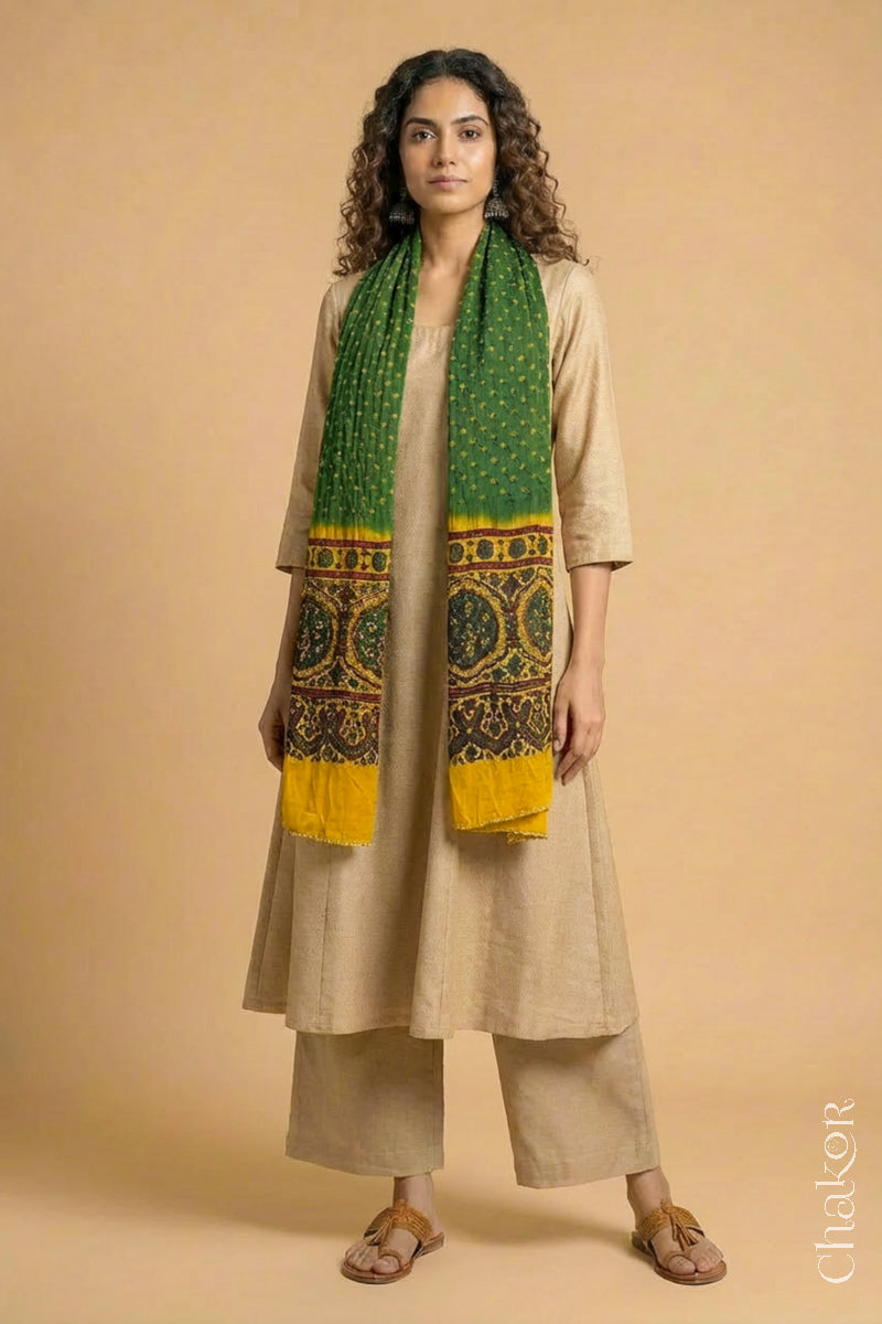 Handcrafted Bandhani Ajrakh modal stole draped on model with Green Bandhani body and Mustard Ajrakh pallu.
